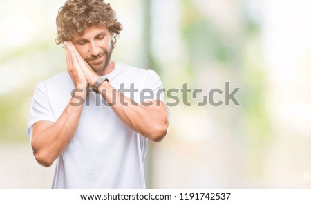 Handsome hispanic model man over isolated background sleeping tired dreaming and posing with hands together while smiling with closed eyes.