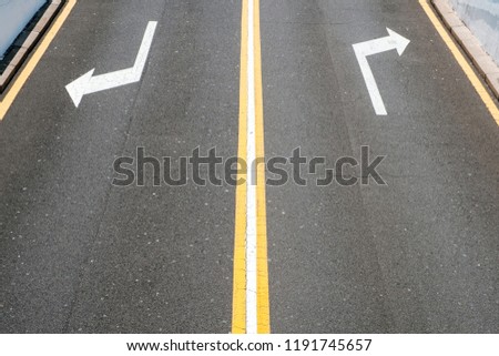 left / right, direction arrows on asphalt road -