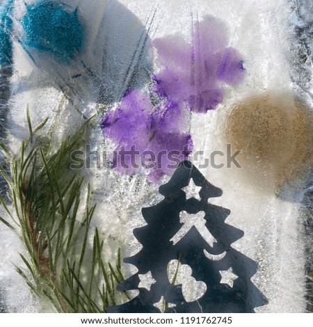 Background of   blue violet flower, blue and gold ball,  Christmas fir  tree and twig of fir tree  in ice   cube with air bubbles.Happy new year 2019 greeting card . 