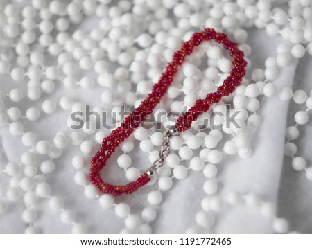 beautiful red seed beads bracelet on white background