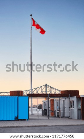 The gate door of the old port Montreal Canada. Canada flag is waving at the top.  