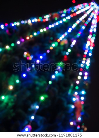 Colored lights on christmas tree blurred bokeh background