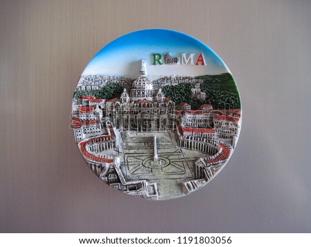 Colorful Italian souvenir fridge magnet from Italy isolated on metallic silver background. Magnet with the symbols of  city of the Vatican in Rome and Saint Peter's Basilica ( St. Peter's Cathedral )