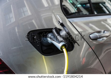 Car plugged into a power station on a street in Amsterdam, Holland 