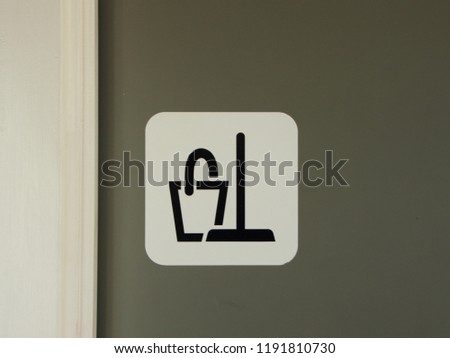 Closeup Cleaning Icon on Entrance Door to Closet. Simple Icon with Black Figure on White Background