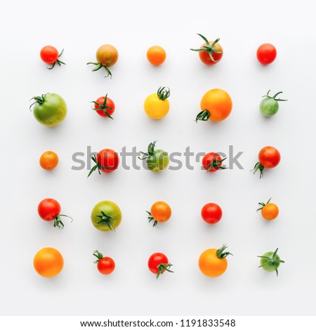 Various colorful cherry tomato pattern on a white background, creative flat lay healthy food concept, top view