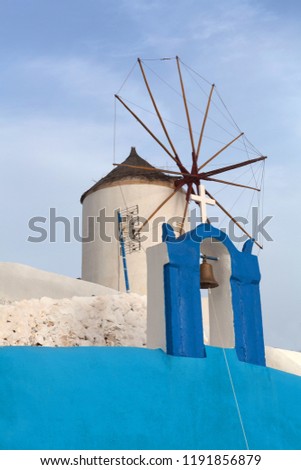 Old white traditional windmill in Oia village on Santorini Island, Cyclades, Greece