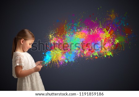 Cute little girl using tablet with colourful splash concept