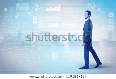 Handsome businessman walking in suit with briefcase on his hand and database concept around