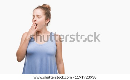 Young blonde woman bored yawning tired covering mouth with hand. Restless and sleepiness.