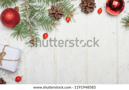 Christmas background with decorations and gift boxes on a white wooden board