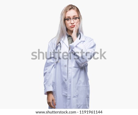 Young blonde doctor woman over isolated background thinking looking tired and bored with depression problems with crossed arms.