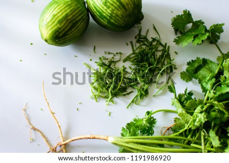 Lime and Cilantro Cooking and fresh green ingredients flat lay food photography background with lime zest citrus fruit