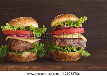 Mini burgers on wooden background