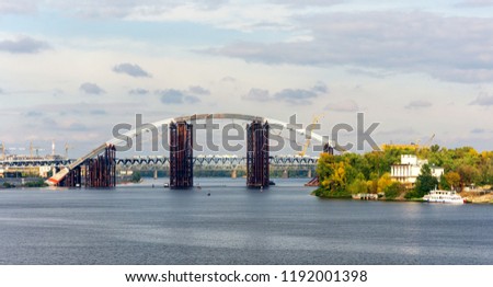 Beautiful panoramic view on the Dnieper River and Podilsko-Voskresensky Bridge, two-level structure for road traffic and subway line, Kyiv, Ukraine. 
