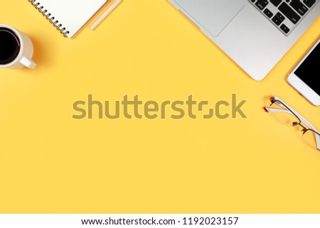 simple workspace technology desk with laptop computer and copy space on yellow pastel background
