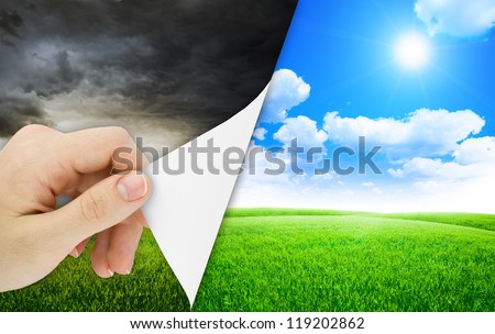 Blank sheet of paper with hand opening it. Storm changes to good weather. Nature background