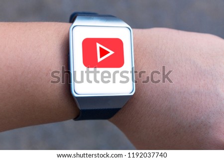 Smartwatch of male hands with social media sign on screen.