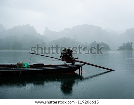 lake view with mountain in the fog during rainy in thailand