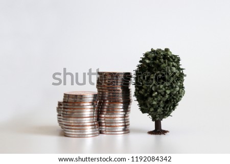The pile of coins with a miniature tree.