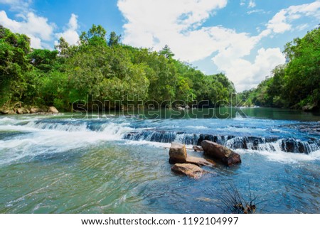 rock over the waterway. Beauty in the nature. Tropical rainforest in Thailand. Waterfall in summer season. Green color in nature