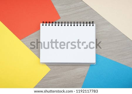 Creative arrangements of stationery on a grey textured background. Top view or flat lay. Education concept. Room for text on spiral book. 