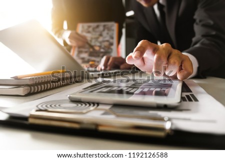 Business team meeting. Photo professional investor working new start up project. Finance task.Digital tablet docking keyboard laptop computer smart phone in morning light
