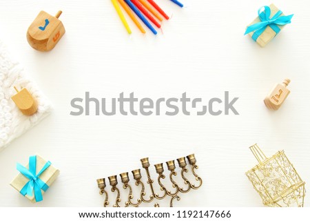 Top view image of jewish holiday Hanukkah background with traditional spinnig top, menorah (traditional candelabra) and candles