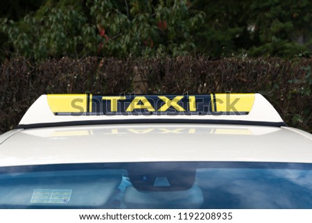 Taxi sign on the roof of a taxi