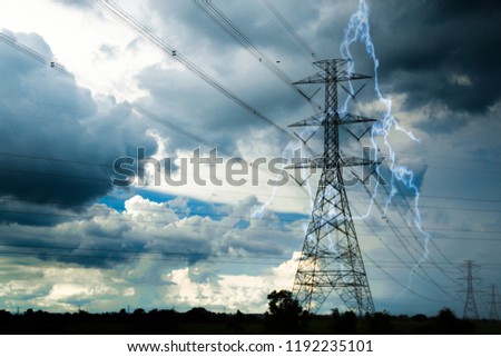 lightning near the high power pole in the field during the storm. Royalty-Free Stock Photo #1192235101