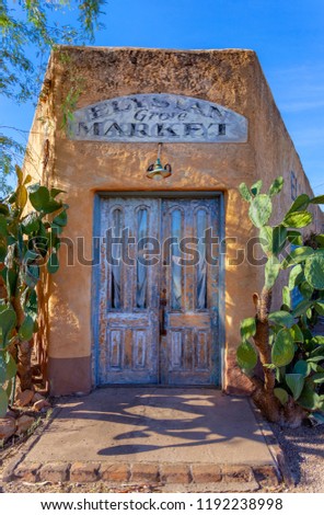 Old abandoned market with blue doors weathered stucco