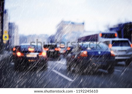 blurred background autumn auto rain on the road / night lights and raindrops in the autumn traffic jam on the road, urban style traffic