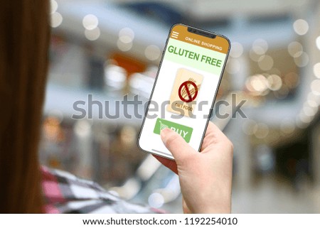 Gluten free diet concept, girl with frameless phone on blurred mall background
