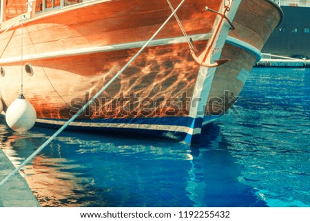 wooden side of the ship in blue water 