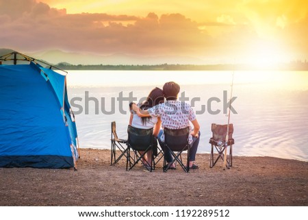 couple traveler have camping and fishing near the lake on vacation. 