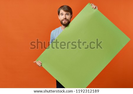 man holding green paper   mockup, poster                   