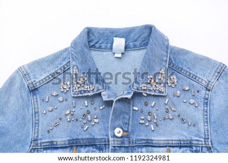 closeup picture of a part of jacket jeans with decoration
