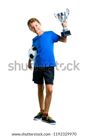 A full-length shot of Boy playing soccer and holding a trophy on isolated white background