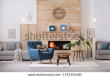 Cozy furnished apartment with niche in wooden wall and armchair. Interior design Royalty-Free Stock Photo #1192341685