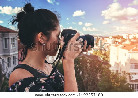 Woman photographer, taking pictures of landscape in old district in Istanbul