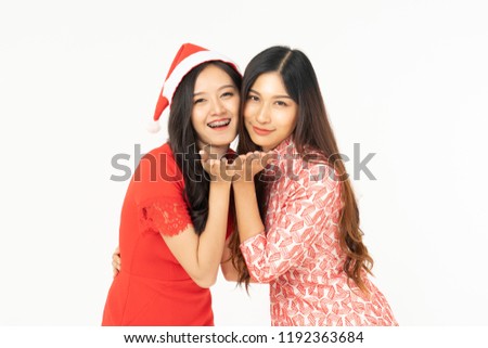 Photo of asian curious woman in red dress rejoicing her birthday or new year gift box. Young woman holding gift  box with red bow being excited and surprised  holiday present isolated white background