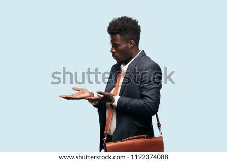 young black businessman smiling with a proud, satisfied and happy look, welcoming gesture or showing and recommending a concept, greeting you.