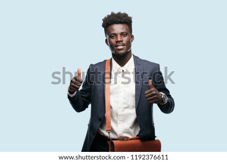 young black businessman with a satisfied, proud and happy look with thumbs up, signaling OK with both hands, sending a positive, "alright' message.