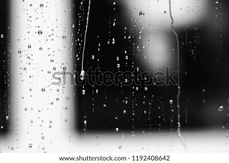 Abstract water drops in a glass window. Raindrops for background texture. black and white picture