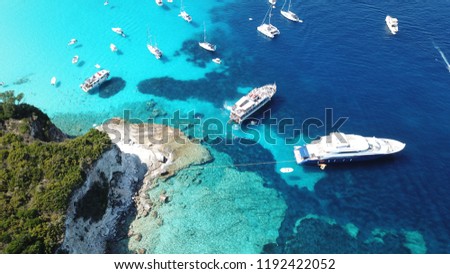 Aerial photo of tropical exotic caribbean bay with sail boats and luxury yachts enjoying deep turquoise ocean sandy beach