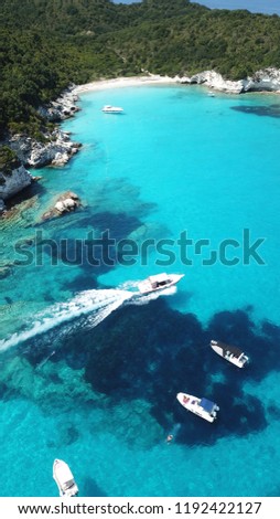 Aerial photo of tropical exotic caribbean bay with sail boats and luxury yachts enjoying deep turquoise ocean sandy beach
