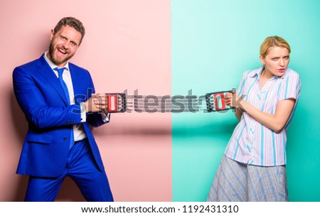 Man and woman stretching expander opposite sides. Business competition between businessman and female. Gender confrontation at workplace. Gender equality and human rights. Business as sport concept.