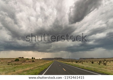 A storm with a dramatic appearance over a road in New Mexico. Now and then lightning struck down from this storm.