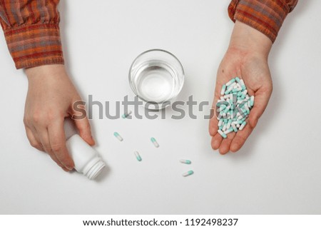 Pill in a hand isolated on white background