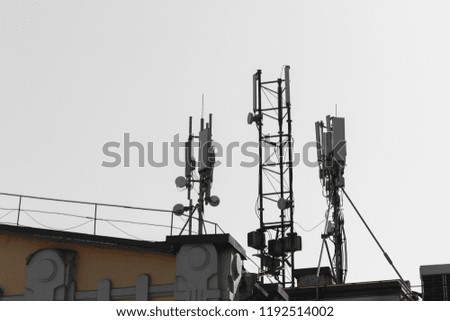 Telecommunication system with wireless communications systems are including microwave, panel antennas, fiber, optic and power cables are located on the roof and city landscape as background